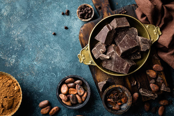 istock Dark chocolate pieces crushed and cocoa beans, culinary background, top view 654544080