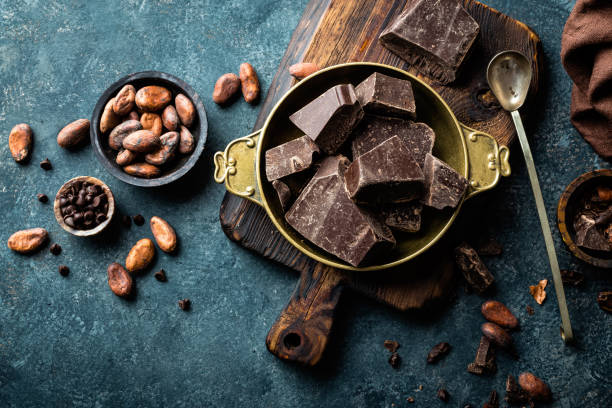 istock Dark chocolate pieces crushed and cocoa beans, culinary background, top view 654544178