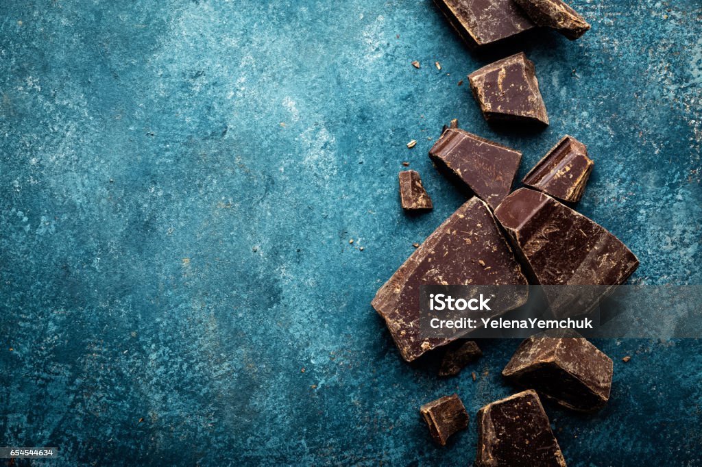 Dark chocolate pieces crushed on a dark background, view from above Dark Chocolate Stock Photo