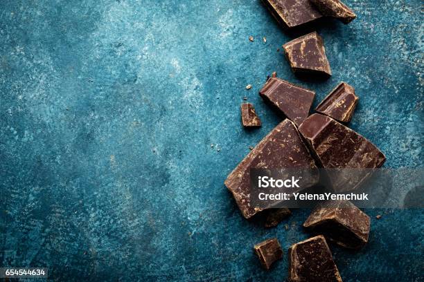 Dark Chocolate Pieces Crushed On A Dark Background View From Above Stock Photo - Download Image Now