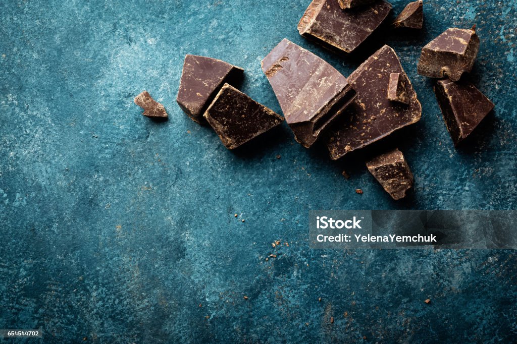 Dark chocolate pieces crushed on a dark background, view from above Chocolate Shaving Stock Photo