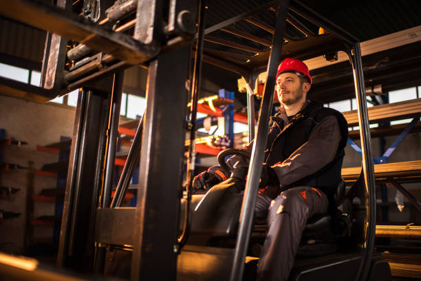 istock Worker driving a forklift in industrial building. 654544906