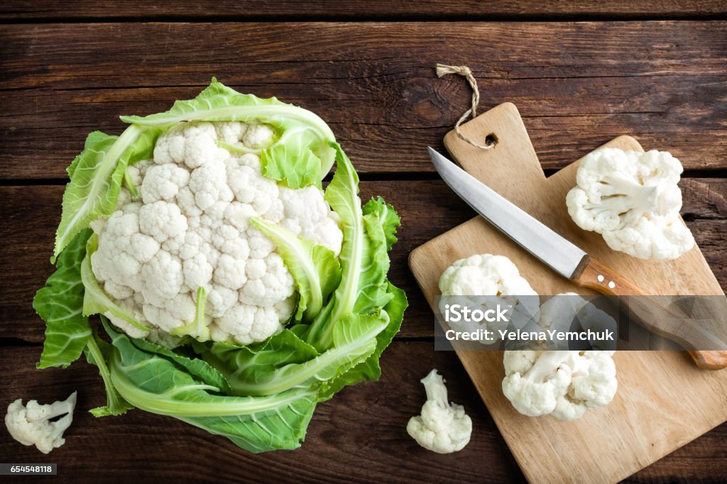 Fresh whole cauliflower on wooden rustic background, top view Cauliflower Stock Photo