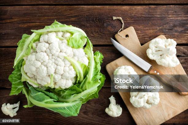 Fresh Whole Cauliflower On Wooden Rustic Background Top View Stock Photo - Download Image Now