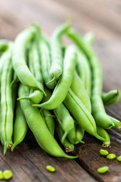 istock Fresh green beans on dark wooden rustic background 654548498