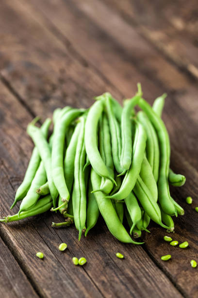 Fresh green beans on dark wooden rustic background