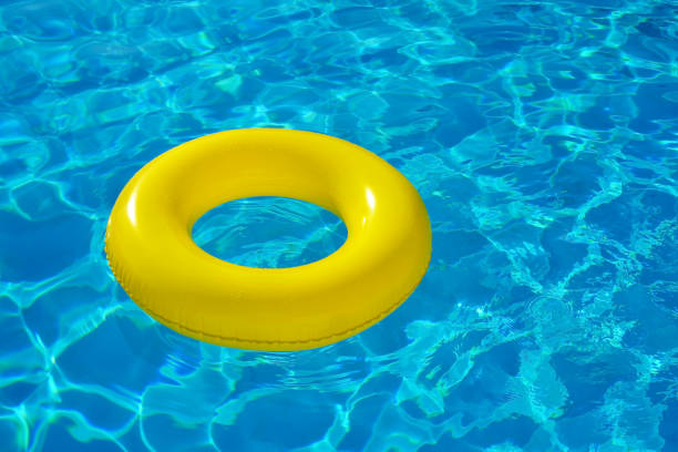 istock Colorful inflatable tube floating in swimming pool 654551688
