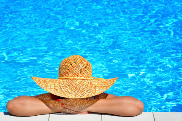 istock Real female beauty relaxing at swimming pool 654555814