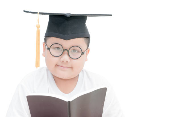 Asian school kid graduate smile with graduation cap isolated on white background