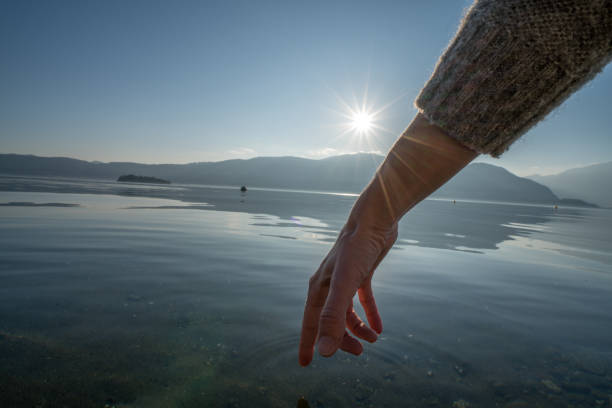 istock Human hand cupped to catch fresh water from lake 654563258