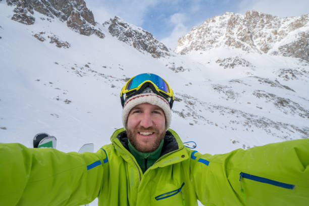 istock Young man taking selfie in ski slope, Switzerland 654563766