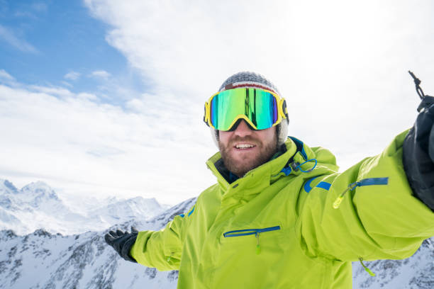 istock Young man taking selfie in ski slope, Switzerland 654566748