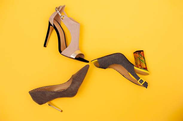 istock Different Elegant Woman Shoes On Yellow Background 654567628