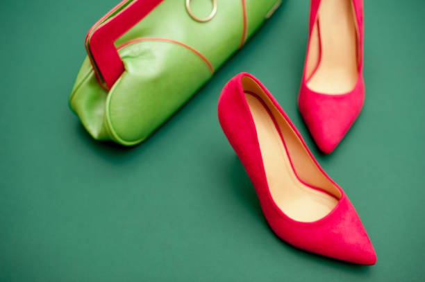 istock Pink And Green Personal Accessory On Green Background 654567770