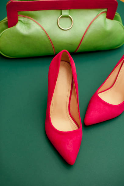 istock Pink And Green Personal Accessory On Green Background 654567778