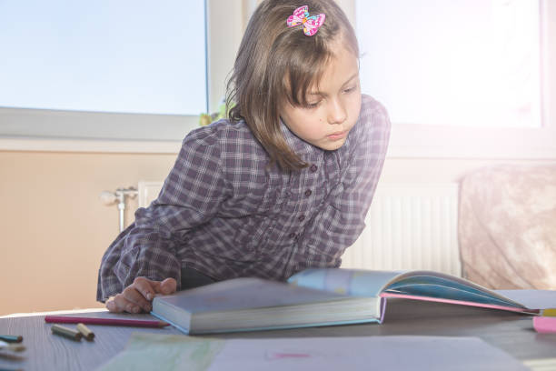 istock Little girl learning to read 654570160