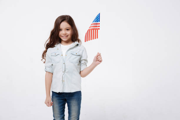 istock Delighted little girl holding the flag in the studio 654570842