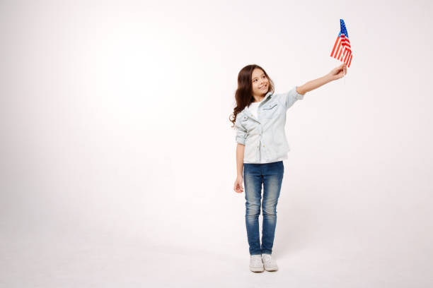 istock Little child showing American symbolic in the studio 654573074