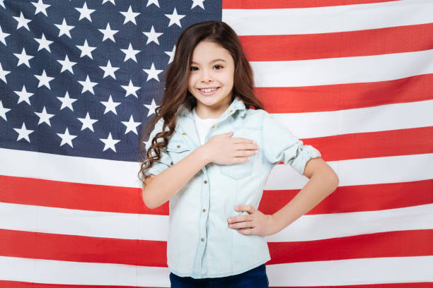 istock Positive little girl posing in the studio 654573942