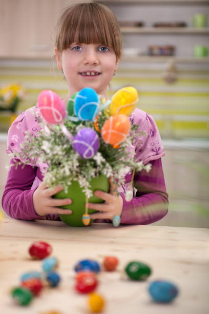 istock happy smiling young girl  holding easter eggs 654575184