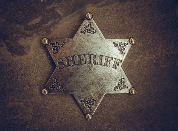 istock Sheriff badge on natural stone background. 654578722