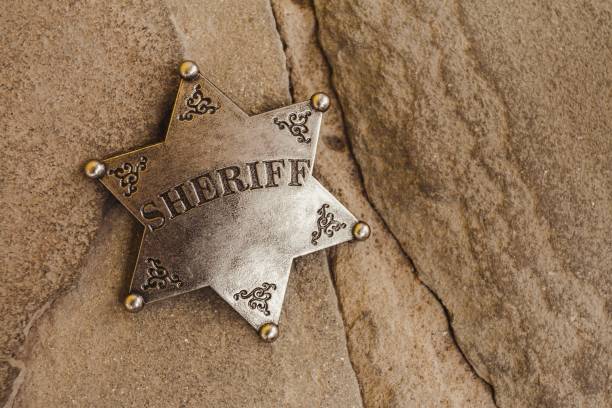 istock Sheriff badge on natural stone background. 654578726