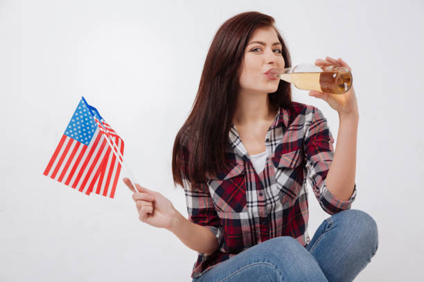 istock Charming young woman drinking beverage in the studio 654581422
