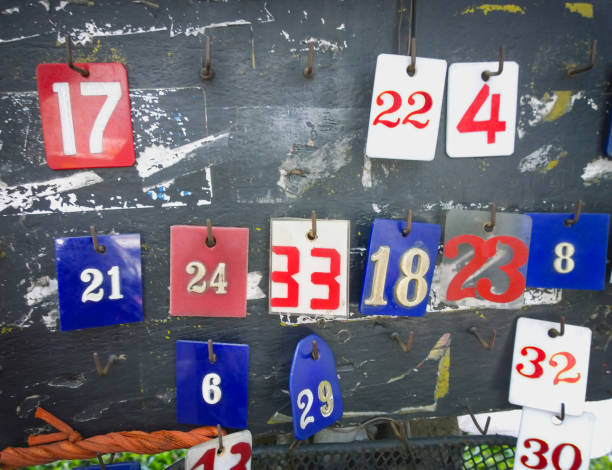 istock Various numbers tags hanging in an old wooden 654588618