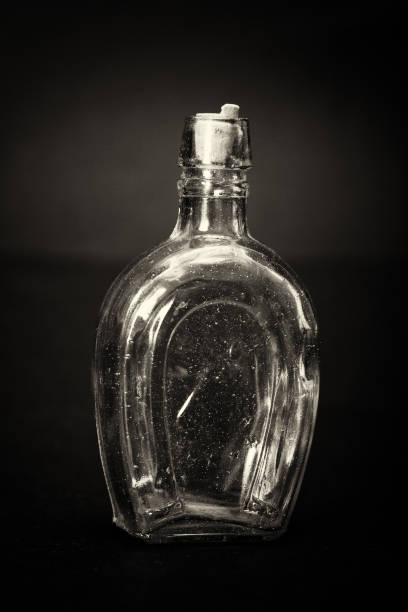 istock Old colourful bottles against a dark background 654589068