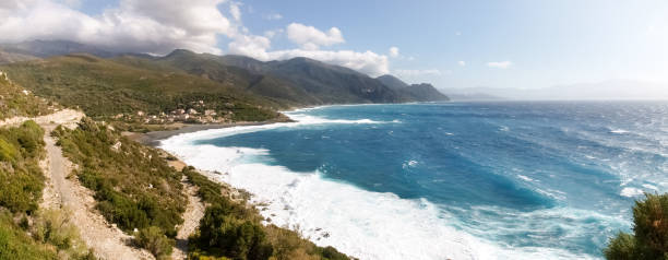 Beach with strong Mistral wind Corsica, France: Coast of Cap Corse and Nonza Beach in rough seas and strong Mistral wind mistral wind stock pictures, royalty-free photos & images