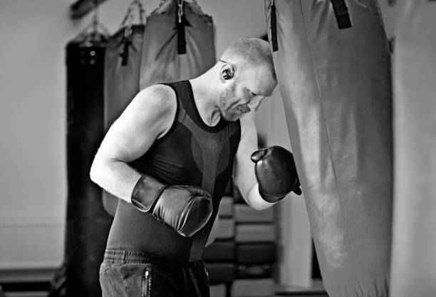 istock Middle Aged Man in Boxing Stance during a boxing workout in the gym 654601216