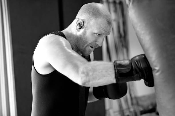 istock Middle Aged Man in Boxing Stance during a boxing workout in the gym 654601290