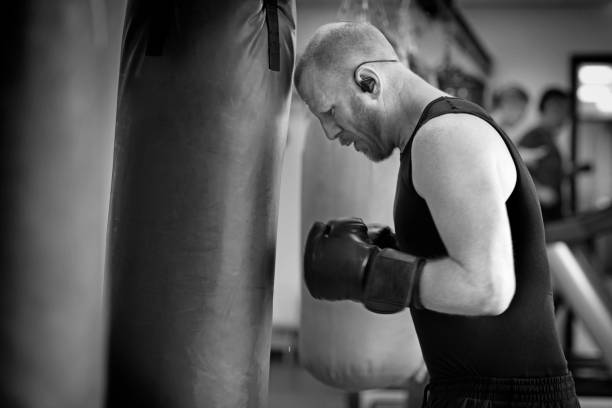 istock Middle Aged Man in Boxing Stance during a boxing workout in the gym 654601292