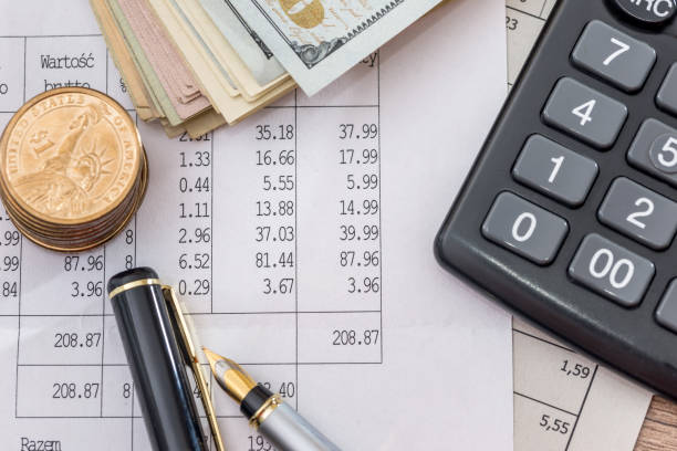 istock Dollar bills with business documents, pen  and calculator as background. 654603858