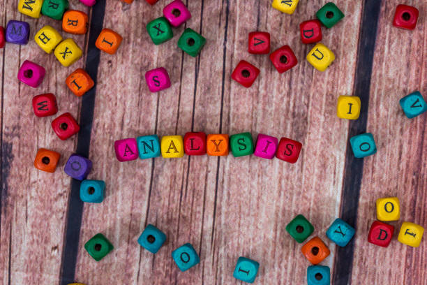 istock analysis - word created with colored wooden cubes on desk. 654603944