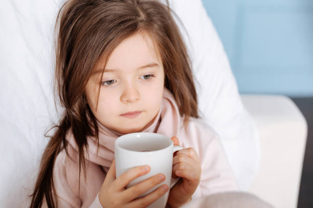 istock Sick little girl drinking tea 654614776