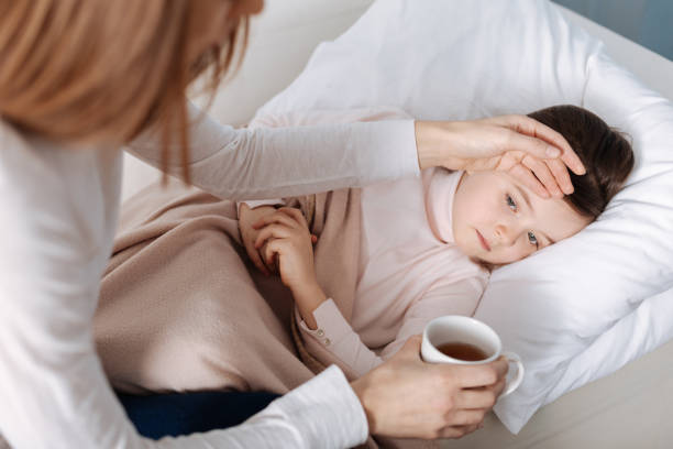 istock Sick little girl lying in bed 654621482