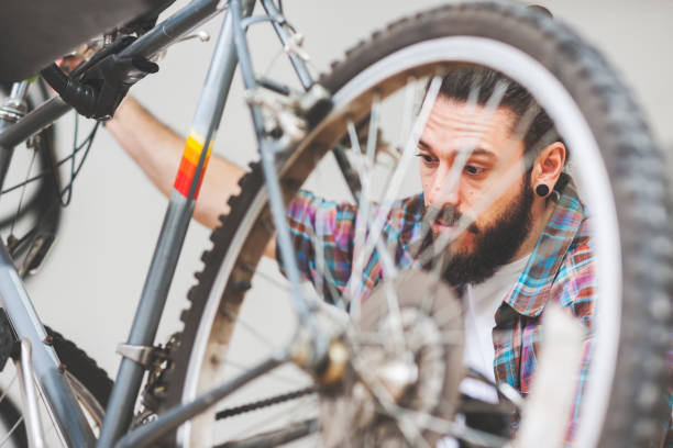 istock Repairman repairing bicycle in workshop 654623198