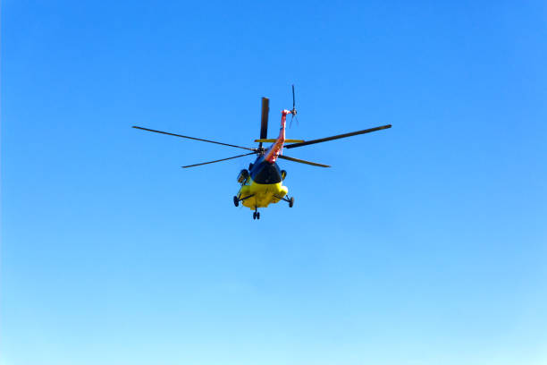 istock A helicopter flies off in the sky 654626194