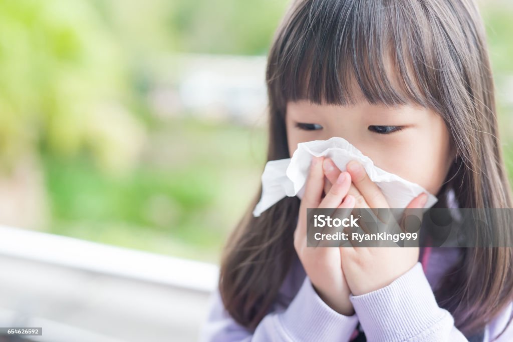 little girl get cold little girl get cold and blow her nose,  asian Child Stock Photo
