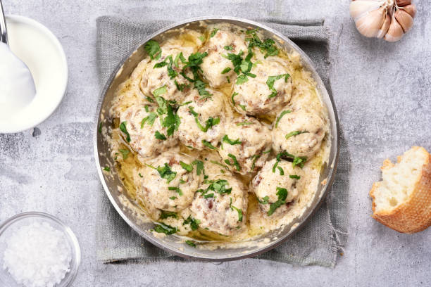 istock Meatballs with white sauce and green herbs 654627672