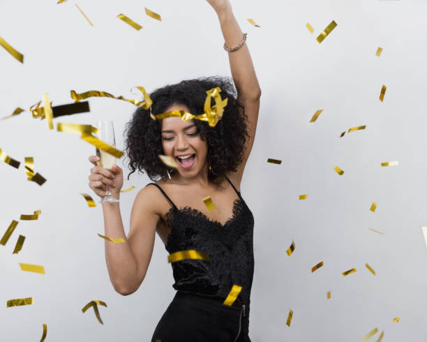 istock Happy woman dancing under confetti 654636232