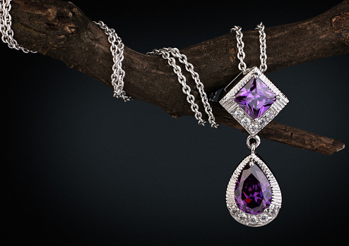 Jewelry  pendant witht gem  amethyst on twig, black background