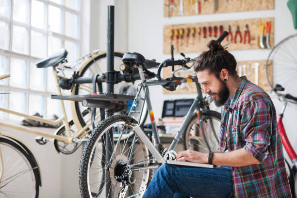istock Repairman repairing bicycle in workshop 654636774