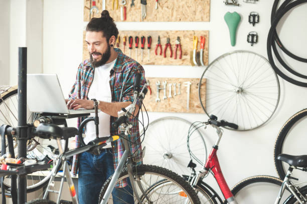 istock Repairman repairing bicycle in workshop 654636818