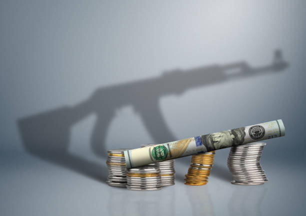 military budget concept, money with gun shadow military budget concept, money with gun shadow terrorist financing stock pictures, royalty-free photos & images
