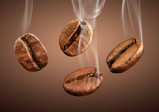 istock falling coffee beans with smoke on brown background 654636968