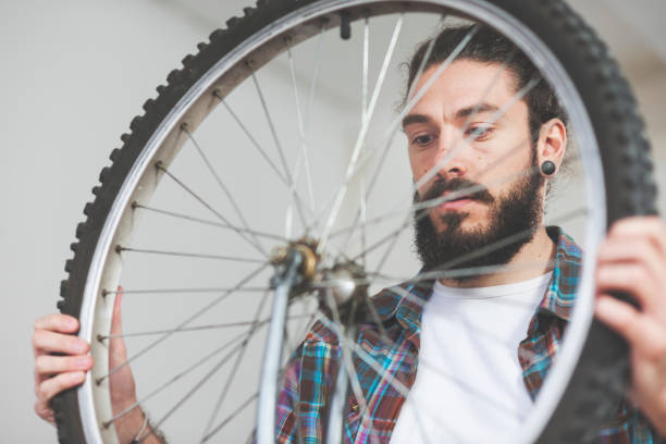 istock Repairman repairing bicycle in workshop 654639652