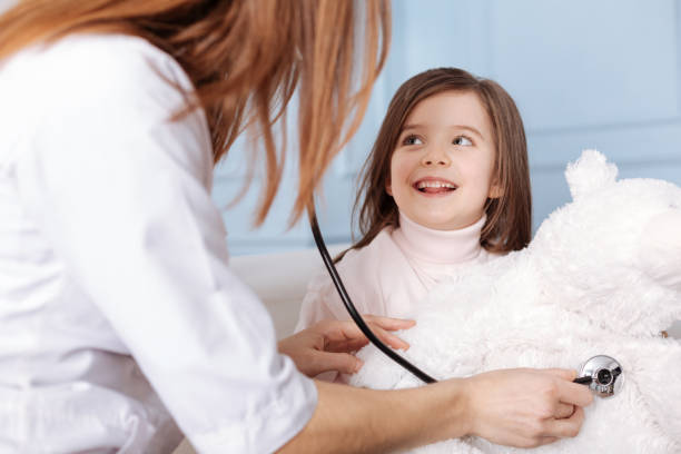 istock Pleasant professional doctor examining a fluffy bear 654643776