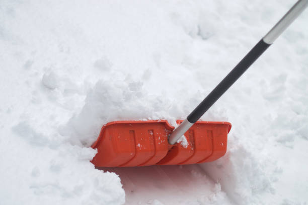 istock Snow shovel in bright orange color in snow 654655332